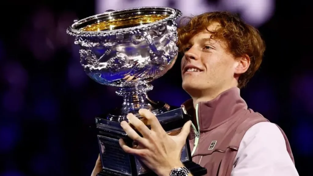 Jannik Sinner celebrates with the trophy after winning the final against Russia's Daniil Medvedev